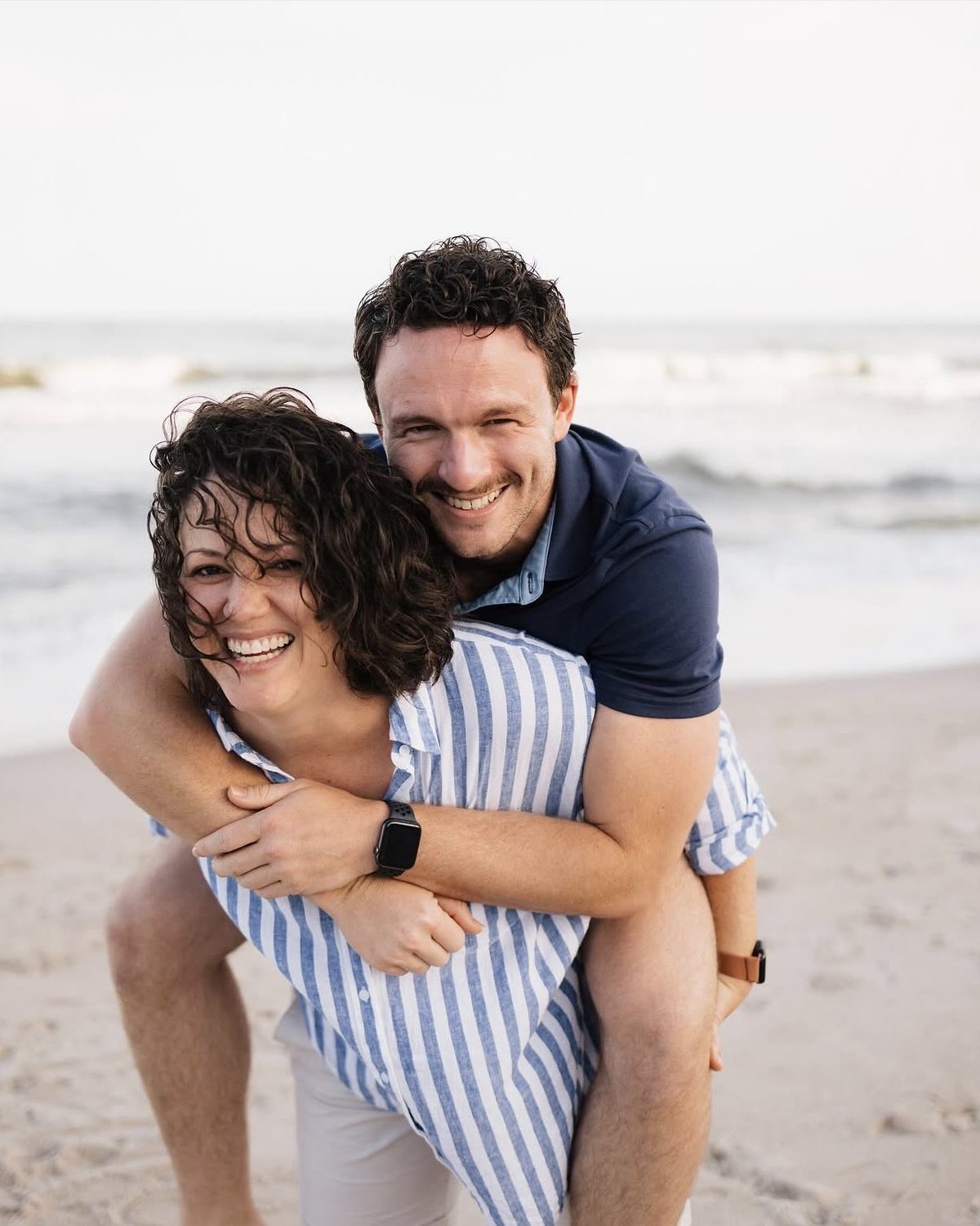 Evan Miller, LCMHC, laughing on the beach with his sister